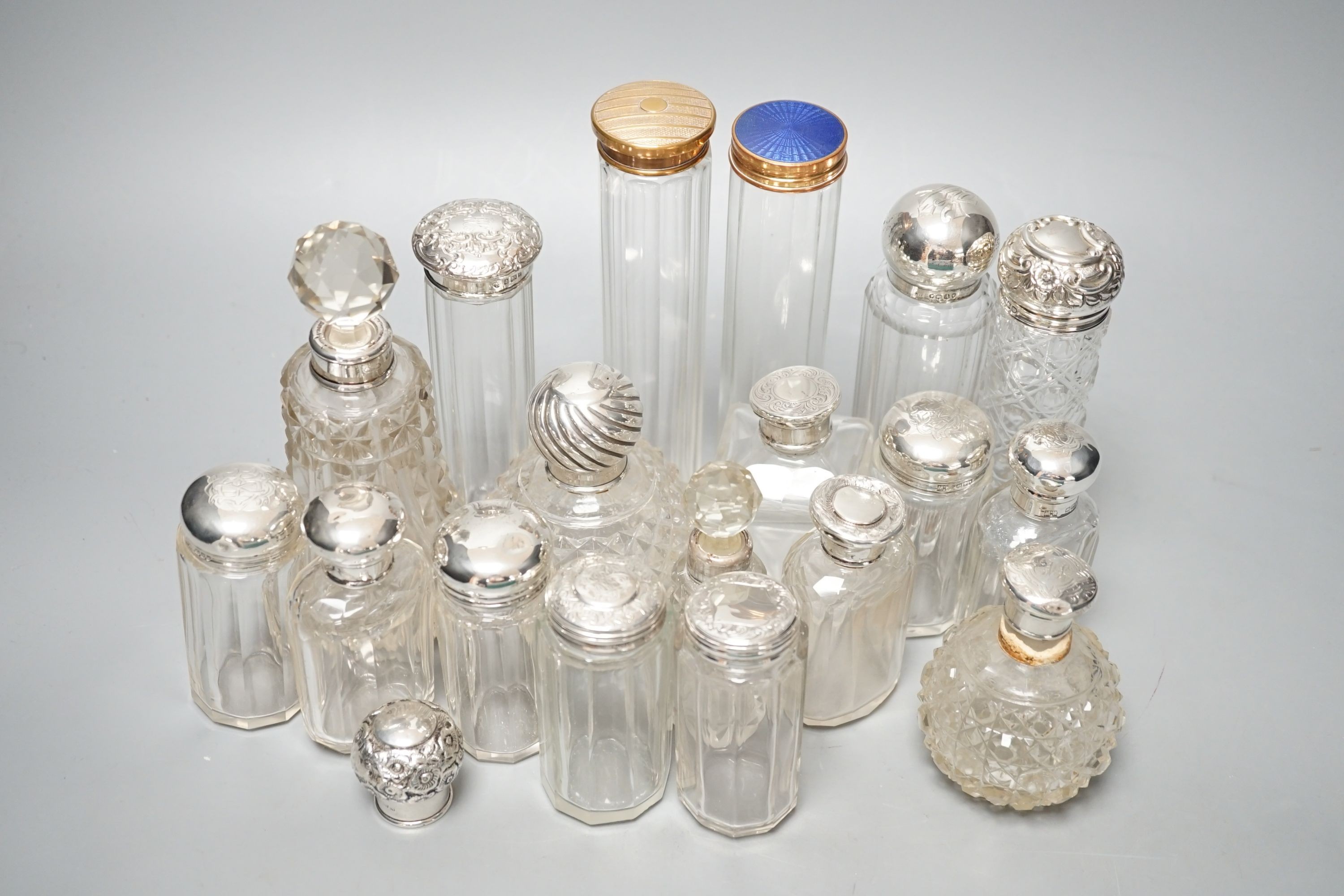 A collection of assorted mainly silver-capped scent bottles and toilet bottles.